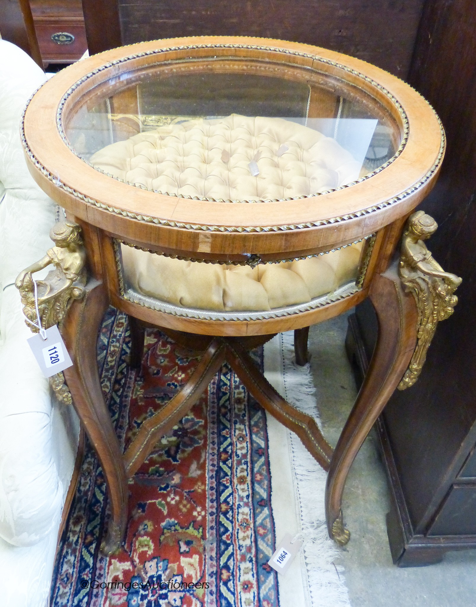 An early 20th century circular bijouterie table with applied cast gilt metal figural mounts, 68cm diameter, height 80cm